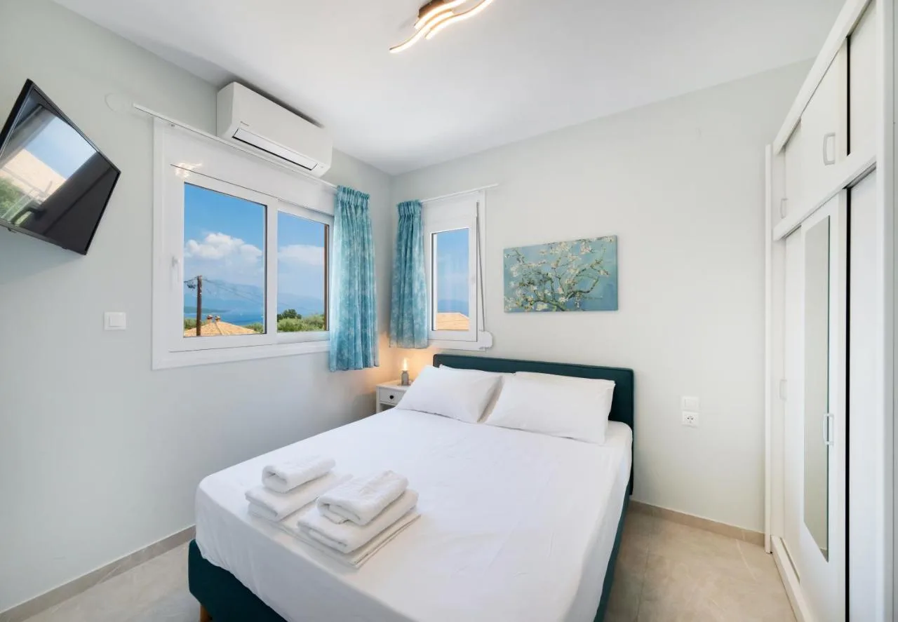 Bedroom with blue accents and bright corner windows