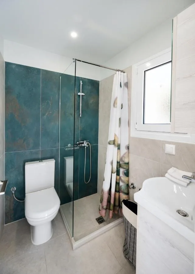 Bathroom with shower and earth-tone tile finishes