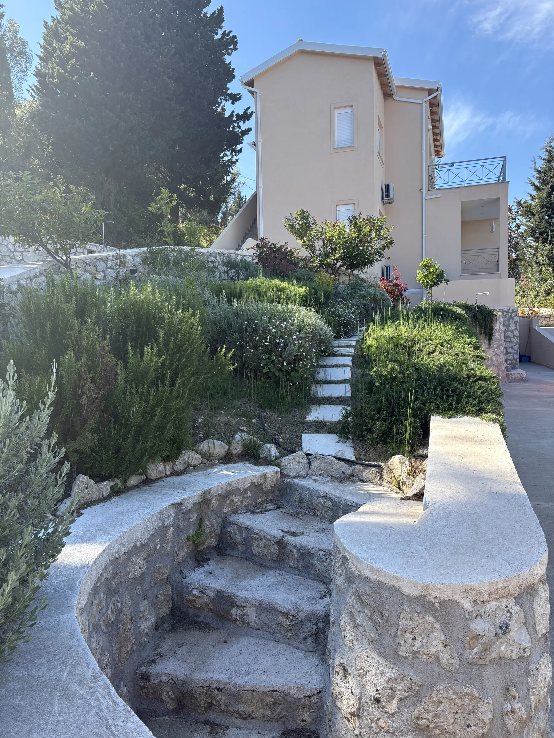Exterior villa wall beside the landscaped garden path
